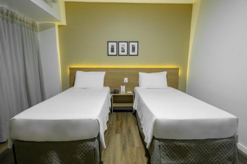 Ένα ή περισσότερα κρεβάτια σε δωμάτιο στο Nobile Suites Diamond