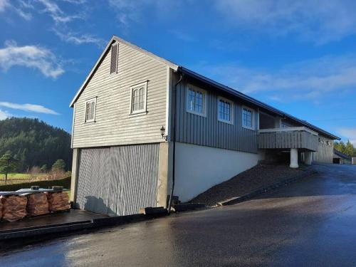a large white building with a large garage at Huset Alcamaro in Haugland