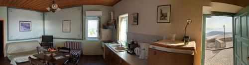 a kitchen with a sink and a table in a room at Gerofotis Traditional Guesthouse est 1892 - Close to Aigio, Akoli, Selianitika in Lákka
