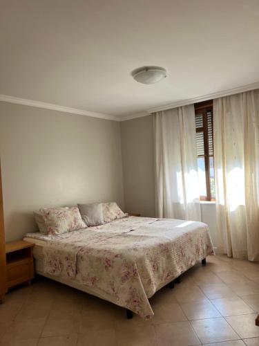 a bedroom with a bed with a blanket on it at Santa Marina Apartment 503 in Sozopol