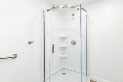 a shower with a glass door in a bathroom at Luxurious 4 BR townhouse in New York