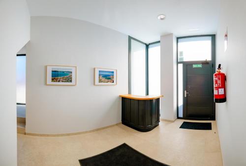 a room with a black door and paintings on the wall at Apartamentos Villa Zoila Nigrán in Nigrán