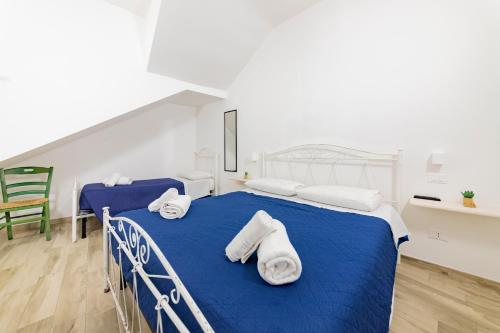 a bedroom with two beds with towels on them at Via Roca 55 in Melendugno