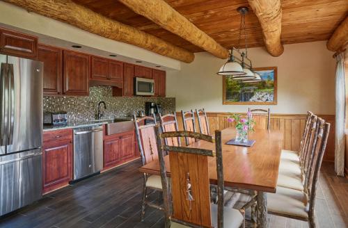a kitchen with a wooden table and a dining room at Seven Springs Resort Properties by Vail Resorts in Champion