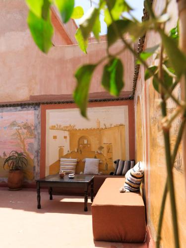 a living room with a couch and a table at Kasbari House in Taghazout