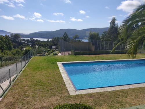 a swimming pool in the yard of a house at Ático de Carmen in Cee