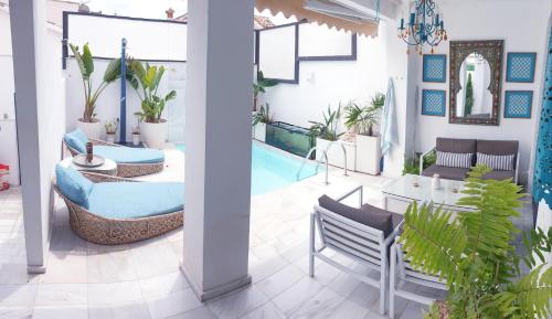 sala de estar con piscina, mesa y sillas en Apartamento MarySol B con Terraza y Piscina privada, en Benalmádena