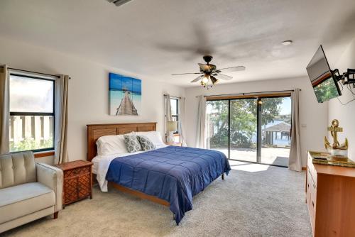 a bedroom with a bed and a ceiling fan at Lovely Palm Coast Retreat with Outdoor Kitchen in Palm Coast