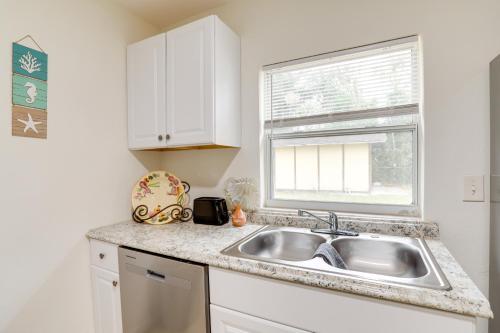 a white kitchen with a sink and a window at Clearwater Vacation Rental Near Downtown and Beaches in Clearwater
