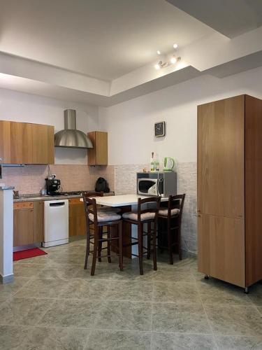 a kitchen with a table and chairs and a stove at Apartments Šterna in Grožnjan