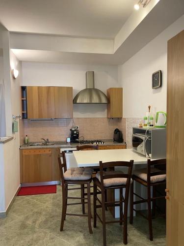 a kitchen with a table and chairs and a stove at Apartments Šterna in Grožnjan