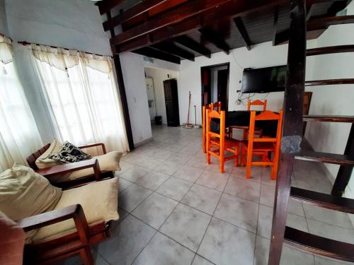 a living room with a table and chairs at departamento villa gesell in Villa Gesell