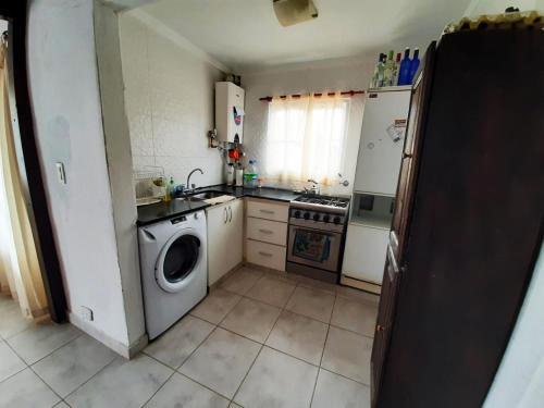 a kitchen with a washing machine and a dishwasher at departamento villa gesell in Villa Gesell