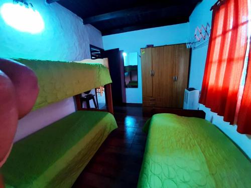 a bedroom with two beds with neon lights at departamento villa gesell in Villa Gesell