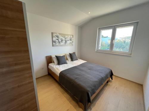 Postel nebo postele na pokoji v ubytování Apartments M&K