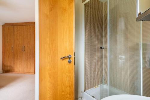 a bathroom with a shower and a glass shower backdoor at 2 Beds Broughton Apartment in Broughton