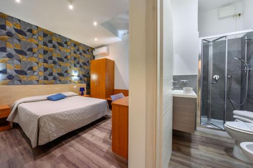a bedroom with a bed and a shower and a toilet at Hotel Anna Siena Nord in Siena