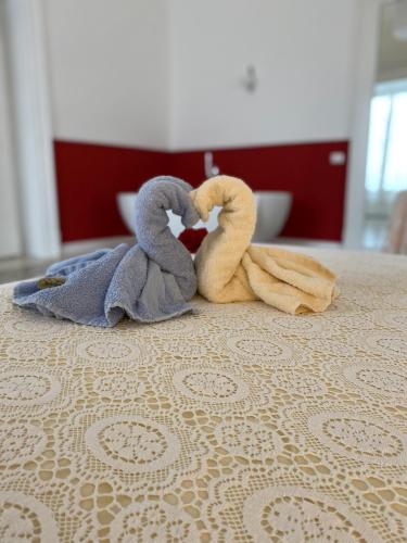a couple of towel animals sitting on top of a bed at Casa di Rita in Catania
