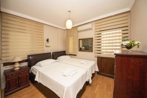 a bedroom with two beds and a window at Enchanting House with Backyard in Bodrum in Bodrum City