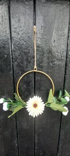 a daisy ornament with a flower on a hook at Plumpton Barn in Ashford
