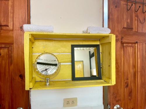 a mirror in a wooden box on a wall at Hostal Inn 2 in Flores