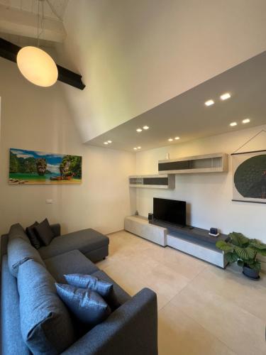 a living room with a couch and a flat screen tv at Tropicale in Rapallo