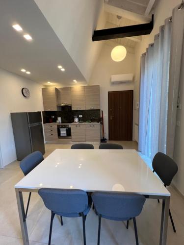 a large white table and chairs in a room at Tropicale in Rapallo