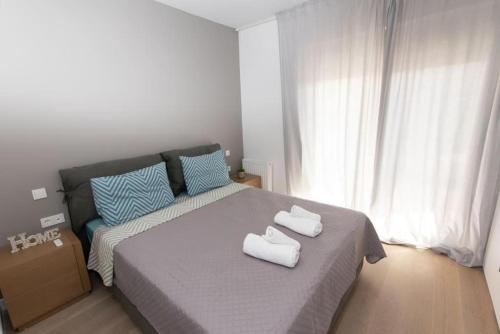 ein Schlafzimmer mit einem Bett mit zwei Handtüchern darauf in der Unterkunft Modern apartment close to Athens city center (Form_F2) in Athen