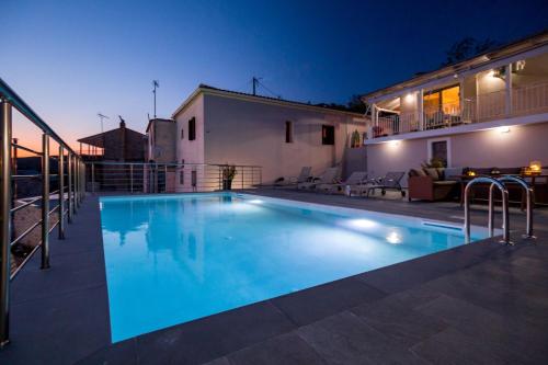 a swimming pool in front of a house at night at The View Villa in Maryiés