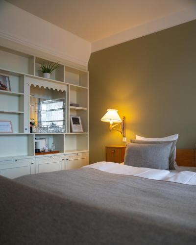 a bedroom with a large bed with a lamp on it at Hotel Alexandra in Copenhagen
