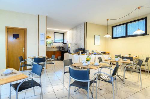 a dining room with wooden tables and chairs at Hotel Anna Siena Nord in Siena