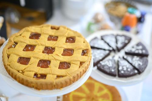 a pie sitting on a white plate on a table at Hotel Anna Siena Nord in Siena