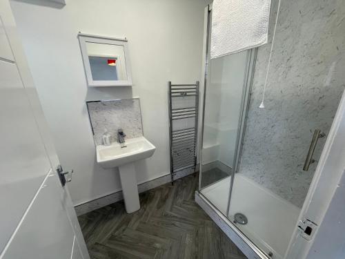 a bathroom with a sink and a shower at Seaside Hotel in Brighton & Hove