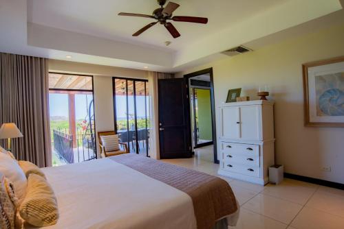 a bedroom with a bed and a ceiling fan at Carao T2-6 Luxury Penthouse Adults Only - Reserva Conchal in Playa Conchal