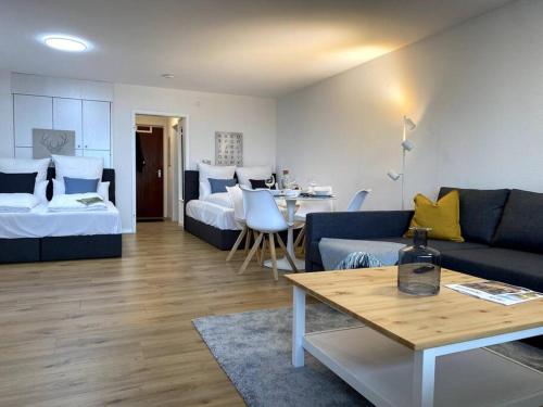 a living room with a couch and a bed and a table at 1-Zimmerapartment mit Burgblick in Bad Liebenzell