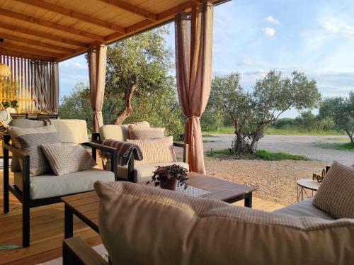 veranda con divani, tavolo e vista su un campo di Zen Zone Premium Mobile Home a Drage