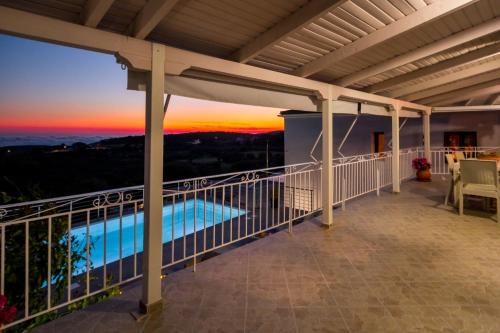a view from the balcony of a house with the sunset at The View Villa in Maryiés