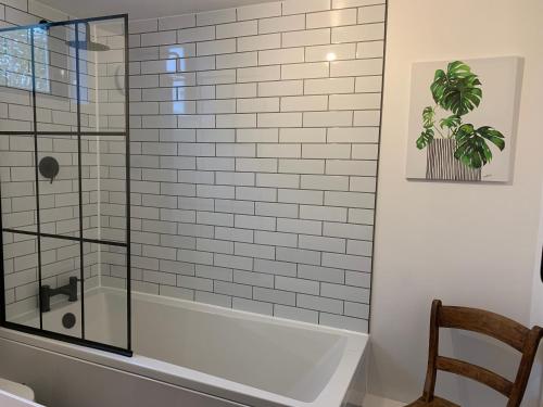 a shower in a bathroom with a glass shower backdoor at St Milburga Chapel in Stoke Saint Milborough