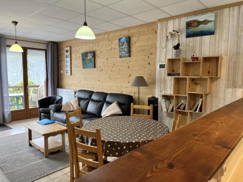 a living room with a couch and a table at gîtes des planchettes in Marigny