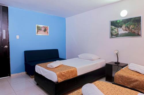 Letto o letti in una camera di Hotel Sol Inn Santa Marta
