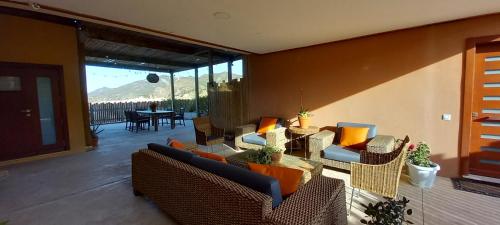 a living room with couches and chairs and a patio at Hotel Makasa in Mogente