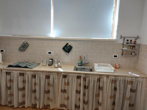 a kitchen counter with a sink and a window at Casabella Mondello in Mondello