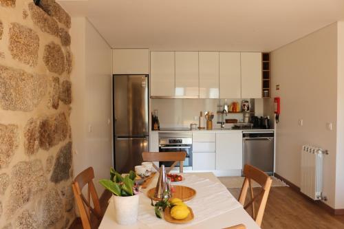 a kitchen with a table with fruit on it at Vila de Campos - Gerês in Vieira do Minho
