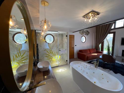 a bathroom with two sinks and a bath tub at Toplik Village Resort in Lukavica