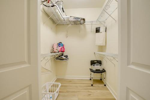 a dressing room with white walls and a hallway with shelves at Calabash Condo with Patio and Golf Course Views! in Calabash