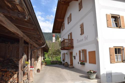 an alleyway between two buildings in a village at Messner Hof in Tires