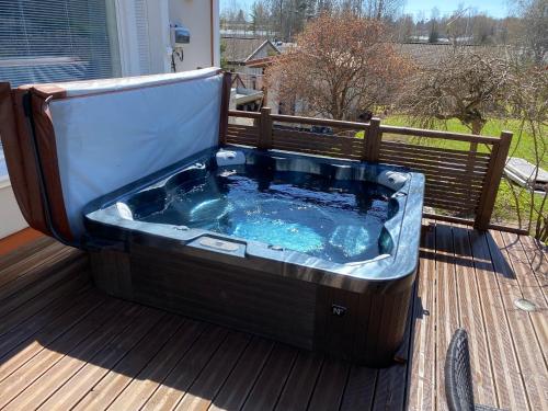 a jacuzzi tub sitting on a deck at Stunning 5BR 16 Bed Home with Finnish Sauna & Jacuzzi 340 m2 in Tampere
