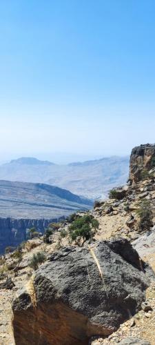 a rock on the side of a mountain at بيت الراحة Rest House in Nizwa