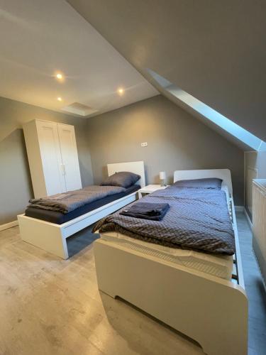 two beds in a room with a attic at City Apartment Bremen in Bremen