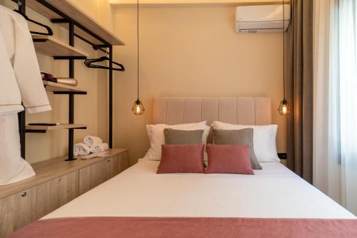 a bedroom with a large white bed with red pillows at Infinity house kavala in Kavala